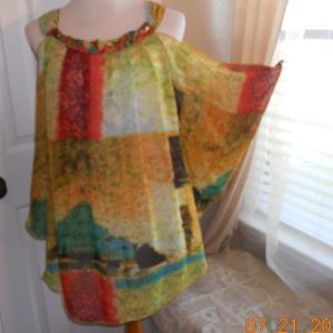 sheer blouse.  peep hole shoulders. braided neck